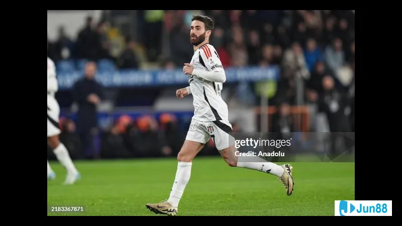 Besiktas player dribbling past Basaksehir defenders during a match